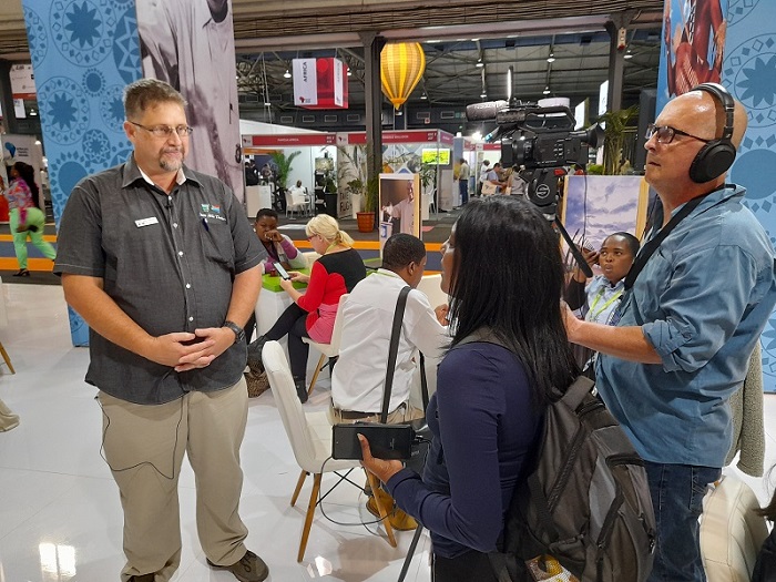 Board member, Shelldon Wells, being interviewed by China TV about the 1000 Hills, at the Travel Indaba.